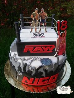 a cake with two men on top of it and the words raw n c d