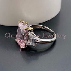 "This Morden LAVISH designer Pink Topaz ring is made with emerald cut pink Topaz with clear topaz side gemstones. The perfect Christmas gift for wife or for Mum. 💎 Main Gemstone: Pink Topaz 10*14mm 💎 Main Gemstone Shape: baguette 💎 Side Gemstones: Clear Topaz 💎 Material: Sterling Silver with rhodium finish. 💎 Band Size - please message us with your correct ring size. If you require any size that is not listed please send me a message. 『 Other Precious metal bands are available in 9k / 14k / Fine Jewelry Pink Rectangular Rings, Pink Diamond Topaz Ring For Anniversary, Pink Emerald-cut Diamond Ring In Fine Jewelry, Pink Emerald Cut Diamond Ring Fine Jewelry, Pink Radiant Cut Diamond Ring As Gift, Pink Radiant Cut Diamond Ring Gift, Pink Radiant Cut Diamond Ring For Anniversary, Radiant Cut Pink Diamond Ring As A Gift, Pink Emerald Cut Diamond Ring