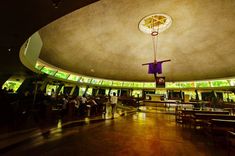 the inside of a church with stained glass windows and people standing in front of it