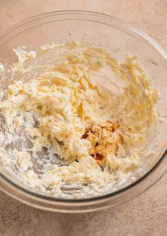 a glass bowl filled with batter on top of a counter