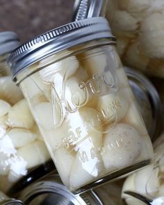 several jars filled with pickled beans sitting on top of a table