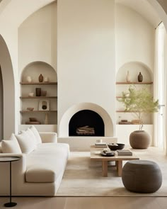 a living room filled with furniture and a fire place in the middle of a room