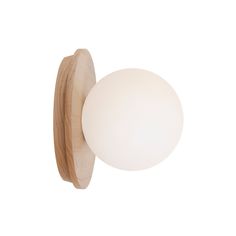 a light that is on the side of a wall mounted lamp with a wooden base