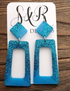 Statement Rectangle Dangle Earrings. Material: Stainless steel, resin, glitter Colour: Blue and Blue Glitter mix Size: 89mm length drop X 28mm wide If you like light weight comfortable earrings then these are for you. Sparkly you can wear everyday or a night out. All metals are made with stainless steel which is perfect for sensitive ears and never changes colour. Blue Rectangular Jewelry For Party, Blue Resin Jewelry For Parties, Blue Resin Jewelry For Party, Blue Glitter Dangle Earrings, Blue Glitter Jewelry For Party, Comfortable Earrings, Resin Glitter, Resin Ideas, Glitter Earrings