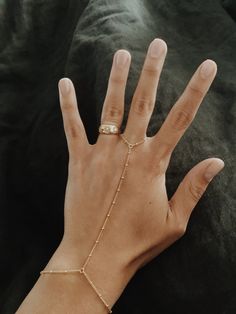 "This is a beautiful beaded hang chain in 14/20 gold-fill. Perfect for when you want something a little more special on your hand. It's great for laying and can be worn and never taken off. 14/20 Gold-fill reacts the same as 14k gold, in that it will never turn silver and if it gets dirty, a little cleaning will bring it back to its original shine! Measurements: The bracelet part of the piece is a little more than 7\", the chain up is 3.5\" and the chain around the finger is 2.5\". But if you ne Gold Beaded Sterling Silver Bracelets, Gold Plated Jewelry With Adjustable Chain And Round Beads, Gold Beaded Bracelet Jewelry, Adjustable 14k Gold Filled Bracelets With Satellite Chain, Gold Beaded Chain Adjustable Body Jewelry, 14k Gold Filled Jewelry With Adjustable Chain, Dainty Metal Jewelry With Round Beads, Delicate Beaded Round Jewelry, Rose Gold 14k Gold-filled Jewelry With Adjustable Chain