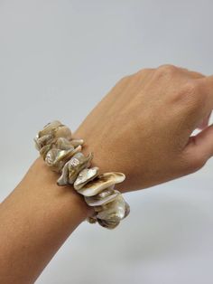 "Natural Sea Shell Bracelet. Puka Shell Bracelet - Stretch bracelet. This Seashell Bracelet is stretch. Beach Bracelet, Surfer Style. Hawaiian Design. This Shell Bracelet is perfect for Womens or Teens Handmade with 3/4\" Inch\" Hand-Selected High Quality Clam Shells. Fits Most Size. Stretch from 5\" Inches up to 6\" Inches. Around the wrist. FAST & FREE SHIPPING! Visit my Etsy Shop to see more Designs! Handmade Puka Necklaces, Bracelets and Earrings: https://www.etsy.com/shop/FreedomLifeSty Elegant Adjustable Stretch Bracelet For Beach, Silver Shell Bracelets Gift, Shell Oyster Bracelet As Gift, White Shell-shaped Bracelet As A Gift, White Shell-shaped Bracelet For Gift, Adjustable Shell Bracelet, Adjustable Oyster Charm Bracelet For Beach, Adjustable Oyster Bracelet Charm For Beach, Oyster Shell Bracelets For Beach