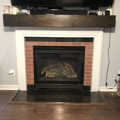 a fire place with a television above it