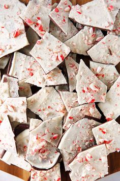 white chocolate with red sprinkles and crushed candy canens on a cutting board