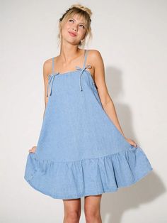 Chic Bow Denim Mini Dress: Your Summer Style Essential Summer Mini Dress With Tie Fastening, Summer Mini Dress With Tie Fastening For Day Out, Chic Summer Mini Dress With Bow, Chic Spring Mini Dress With Bow, Chic Mini Dress With Bow For Spring, Casual Summer Mini Dress For Picnic, Cotton Summer Dress With Tie Fastening, Chic Cotton Mini Dress With Tie Fastening, Summer Mini Dress With Tie Fastening For Beach