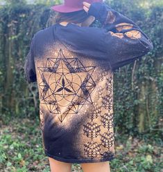 The design for this long sleeve shirt is based on the 64 point tetrahedron. Every image in the stencils used in this design can be created by connecting the major intersections of the grid laid out by this shape. The 64 point star tetrahedron in its three dimensional depiction is on the front of the shirt, overlaying its two dimensional version, the 64 Point Tetrahedron grid. Lining the sides of the shirt under the sleeves are three rows of three dimensional 64 Point Star Tetrahedrons. Down one Long Sleeve Tops With Star Print For Fall, Long Sleeve Star Print Tops For Fall, Long Sleeve Star Print Tops For Streetwear, Long Sleeve Tops With Star Print For Streetwear, Long Sleeve T-shirt With Sublimation Print, Long Sleeve Shirt With Sublimation Print And Relaxed Fit, Long Sleeve Shirt With Sublimation Print, Relaxed Fit, Relaxed Fit Long Sleeve Shirt With Sublimation Print, Long Sleeve Shirt With Sublimation Print