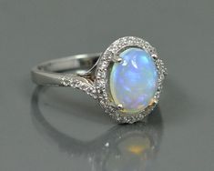 This Listing is For-: Natural Ethiopian Fire Opal Ring, 925 Silver Ring, Gemstone Ring, October Ring, Handmade Ring, Engagement Ring, Wedding Ring, Bridal Ring.PRODUCT CODE            ---            RJ-6192BIRTHSTONE                  ---            OCTOBER METAL                             ---            925 STERLING SILVERPRODUCTS TYPE         ---              RINGSTONE DIMENSION    ---              10x8 MM  STONE WEIGHT           ---              1.55 CTS.TOTAL WEIGHT           --- Formal Silver Opal Ring With Halo, Silver Opal Ring With Halo Setting For Formal Occasions, Silver Opal Ring With Halo Design For Formal Occasions, Formal Silver Opal Ring With Halo Design, Formal Silver Opal Ring With Halo Setting, Silver Opal Wedding Ring Hallmarked, Silver Hallmarked Opal Wedding Ring, Silver Opal Ring With Halo For Anniversary, Sterling Silver Opal Ring With Halo Design For Wedding