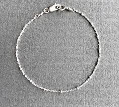 "Dainty Sterling Silver Chain Bracelet The perfect dainty chain to wear everyday! This satellite chain has such incredible shine and sparkle. Really pretty when layered with other bracelets and a terrific addition to any jewelry collection. ✦Also available in 14K gold fill - please see link below ✦For Satellite Necklace lengths - please see link below DESCRIPTION * Sterling Silver Satellite Chain, Lobster/trigger Clasp and Components * This is a delicate cable chain with accent beads of approxim Silver Delicate Adjustable Chain Bracelet, Delicate Silver Adjustable Chain Bracelet, Nickel-free Link Chain Bracelet Minimalist Style, Nickel-free Minimalist Link Chain Bracelet, Minimalist Nickel-free Link Chain Bracelet, Sterling Silver Satellite Chain Bracelet For Everyday, Everyday Sterling Silver Chain Bracelet With Satellite Chain, Silver Link Bracelet With Delicate Chain, Everyday Sterling Silver Satellite Chain Bracelet