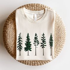 "TALL EVERGREEN TREES BELLA+CANVAS UNISEX TEE Tall Evergreen Trees Shirt Fall Evergreen Shirt Christmas Trees Pine Tree Tee Pine Tree Shirt Mountain Lover Hiking Shirt Camping Shirt Please keep in mind processing times can take 2-7 business days to be made and 3-6 business days to be shipped with an estimated delivery date of 7-10 days. - Please note that these times are estimated by USPS and may take longer - Please make sure your shipping address is correct before placing an order - Printed an Casual Green Top As Gift, Green Graphic Print Top As Gift, Green Graphic Print Top For Gift, Green Casual Top, Green Crew Neck Christmas Shirt, Green Long Sleeve T-shirt For Holiday, Green Long Sleeve Tops As Gift, Christmas Green Cotton Tops, Green Cotton Christmas Tops