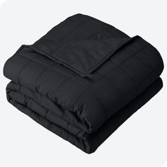 the black comforter is folded on top of each other