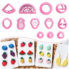 various fruits and vegetables shaped cookie cutters on top of a table next to paper