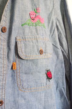 Vintage Levi's embroidered button down shirt. Two front pockets. Three ladybugs, pink worm wearing hat and floral vines. One button missing. No tears or stains. Excellent vintage condition. Casual Tops With Embroidered Patch For Spring, Casual Spring Tops With Embroidered Patch, Casual Long Sleeve Shirt With Custom Embroidery, Casual Shirt With Custom Embroidery For Spring, Casual Spring Shirt With Custom Embroidery, Casual Pink Embroidered Shirt, Vintage Blue Embroidered Top, Vintage Embroidered Button-up Shirt, Blue Button-up Shirt With Floral Embroidery