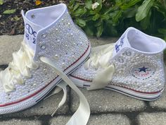 Embroidered Converse! Monochrome All WHITE Converse with white and ivory mixed pearls and rhinestones encrusted all over the shoe. ! I can do all white pearls or all ivory. (I will do the mixture if you do not specify in your order ) These shoes will sparkle and get noticed across the room! They are beautifully embroidered and hand done and each pair will be a bit different. This listing shows the I Do pattern but I can put your name or monogram on them as well as the date or Mrs. Smith. Your ch White Wedding Shoes With Pearl Embroidery, Embellished White Wedding Shoes For Bridal Shower, White Embellished Low-top Wedding Shoes, Wedding White Embellished Sneakers, Embroidered Wedding Shoes, All White Converse, Embroidered Converse, Wedding Converse, Mrs Smith