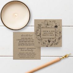 the wedding stationery is laid out next to a candle