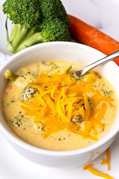 a bowl of broccoli cheese soup with carrots