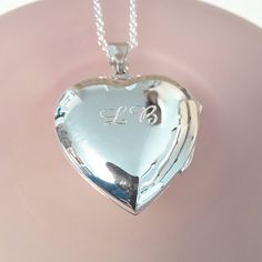 "A large heart shaped locket in polished sterling silver is suspended on an elegant sterling silver rolo chain. Perfect for holding two photos or bits of special paper. Choose to leave it blank or have it professionally engraved on one or both sides (outside only). ✩ Sterling silver locket is 25mm wide. ✩ Sterling silver 2mm rolo chain closes with a spring ring clasp. All components are sterling silver. Total length is end-to-end including all clasps. Model is wearing an 18\" chain. ✩ Personaliz Silver Heart Locket, Heart Shaped Locket, Engraved Locket, Sterling Silver Locket, Silver Locket, Gold Vermeil Jewelry, Heart Locket Necklace, Large Heart, Silver Lockets