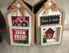 two small wooden houses with farm fresh signs on the front and back, hanging from twine