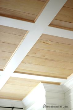 the ceiling in this kitchen is made of wood planks and painted white with light coming through