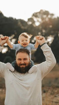 a man holding a child on his shoulders