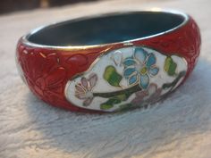 Here we have a Vintage Chinese Wide Red Carved Cinnabar Enamel Cloisonne Floral Bangle Bracelet, Cinnabar Bracelet, Floral Enamel Bracelet, MCM Bracelet.  This is a nice Bracelet and it is in good condition but it has been worn and does show wear especially on the rim of the bracelet.  I did nothing to it so it has a couple black marks in the red which one can see if they zoom in on photos, otherwise clean and wear it this Spring and Summer and I am sure you will get remarks on it...  It is 7/8t Traditional Red Bangle For Formal Occasions, Red Bracelets For Ceremonial Festivals, Adjustable Red Bangle For Ceremonial Occasions, Red Bracelets For Festivals, Red Ceremonial Bracelets For Festivals, Traditional Red Cuff Bracelet As Gift, Red Bangle For Formal Festivals, Festival Red Bracelets, Handmade Red Cuff Bracelet For Formal Occasions