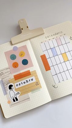 an open planner book with stickers on it