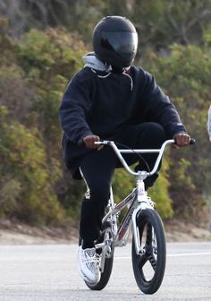 two people riding bikes on the road