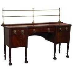 an antique wooden desk with two drawers on one side and brass fittings on the other