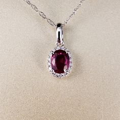 "Ruby and Diamond Pendant 14k White Gold pendant is featuring a 4.62X5.95mm Oval Genuine Ruby .69ct . This Beautiful Ruby has a Halo of .07ct Genuine Diamonds surrounding it. Classic and beautiful. **Ruby is the official July Birthstone** **Diamond is the official April Birthstone** **This listing is for the pendant only. Chain not included, for display purposes only. 14k Yellow Gold chains available for purchase upon request. **Please feel free to contact me anytime, if you have any questions o Halo Style, Ruby Pendant, April Birthstone, Halo Pendant, Gold Halo, Jade Ring, July Birthstone, Jade Jewelry, Yellow Gold Chain