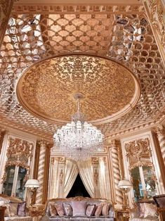 an elaborately decorated living room with chandelier and couches