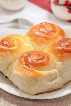 three cinnamon rolls on a white plate