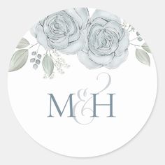 two roses and leaves on the front of a round wedding sticker