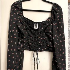 Beautiful Maiden Lace Up Blouse . Black Long Sleeve With Flower Pattern . Size Medium Cropped ,Low Square Neck And Stretchy Back .Never Worn. Practically New !!!! So Pretty Black Floral Print Blouse For Fall, Black Crop Top Blouse For Spring, Black Floral Print Tops For Fall, Floral Print Crop Top For Fall, Floral Print Crop Top Blouse For Day Out, Floral Crop Top Blouse For Day Out, Black Floral Print Crop Top, Casual Floral Print Crop Top Blouse, Chic Black Floral Print Tops