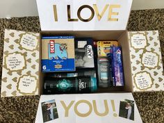 an open box with various items in it that say i love you and have been placed on the floor