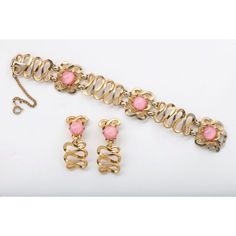 This is part of Chairish’s Costume Jewelry assortment.  Great Schiaparelli loopy "gold"set with pink cabochon stones. Earrings are 1  3/4" high by 3/4" wide by 5/8" deep. Pink Metal Jewelry For Formal Occasions, Pink Cabochon Jewelry For Formal Occasions, Pink Costume Jewelry For Evening, Evening Pink Costume Jewelry, Evening Costume Jewelry With Cabochon, Evening Cabochon Costume Jewelry, Pink Costume Jewelry For Formal Occasions, Pink Formal Costume Jewelry, Formal Pink Costume Jewelry