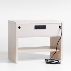 an electronic device is plugged into the side of a table