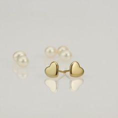 These are small gold heart stud earrings, handmade of 14k solid gold.Modern yellow gold Heart earrings, with a highly shiny finish.These heart studs are perfect for every day’s wear, and will look great with any style.They will add a chic gold touch and sparkle to your appearance.A wonderful gift for yourself or for someone you love. Heart’s size is approx 6.8 x 6.2 mm = 0.26 x 0.24 inch Heart is 1.4 mm thick = 0.05 inch.14k solid gold ear backs are included.*I can make these earrings in matte f Minimalist Gold Hypoallergenic Heart Earrings, Dainty Yellow Gold Sterling Silver Heart Earrings, Classic 14k Gold Heart Charm Earrings, Minimalist Gold Heart Earrings With Charm, Minimalist Yellow Gold Heart Earrings For Valentine's Day, Tiny Dainty Yellow Gold Heart Earrings, Minimalist Heart-shaped Yellow Gold Earrings, Dainty Tiny Yellow Gold Heart Earrings, Dainty Heart-shaped Yellow Gold Earrings