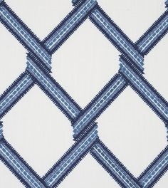 a blue and white fabric with diamond shaped design on the front, in an upholstered pattern