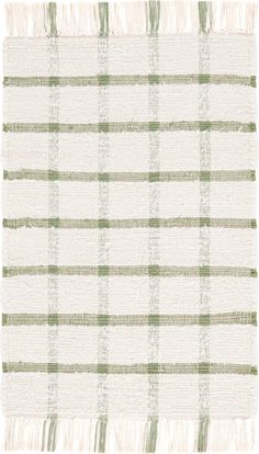 a white and green plaid rug with fringes