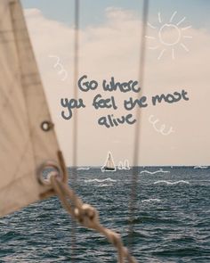 a sailboat sailing in the ocean with a quote written on it's side