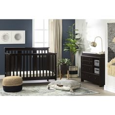 a baby's room with a crib, dresser and other furniture in it