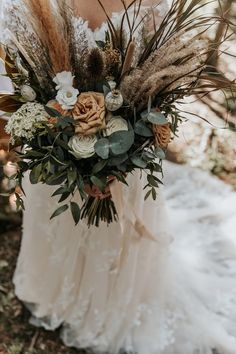 a bridal bouquet with dried flowers and foliage