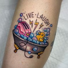 a tattoo on the leg of a person with a bathtub and rubber duck in it