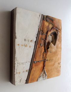 a piece of wood that has been painted white and rusted with some paint on it