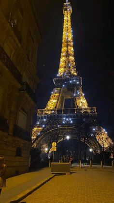 the eiffel tower is lit up at night