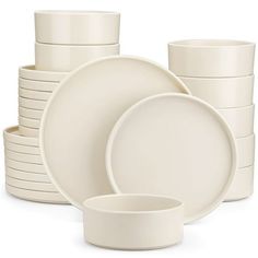 a stack of white dishes and cups