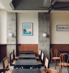 an empty restaurant with wooden tables and chairs